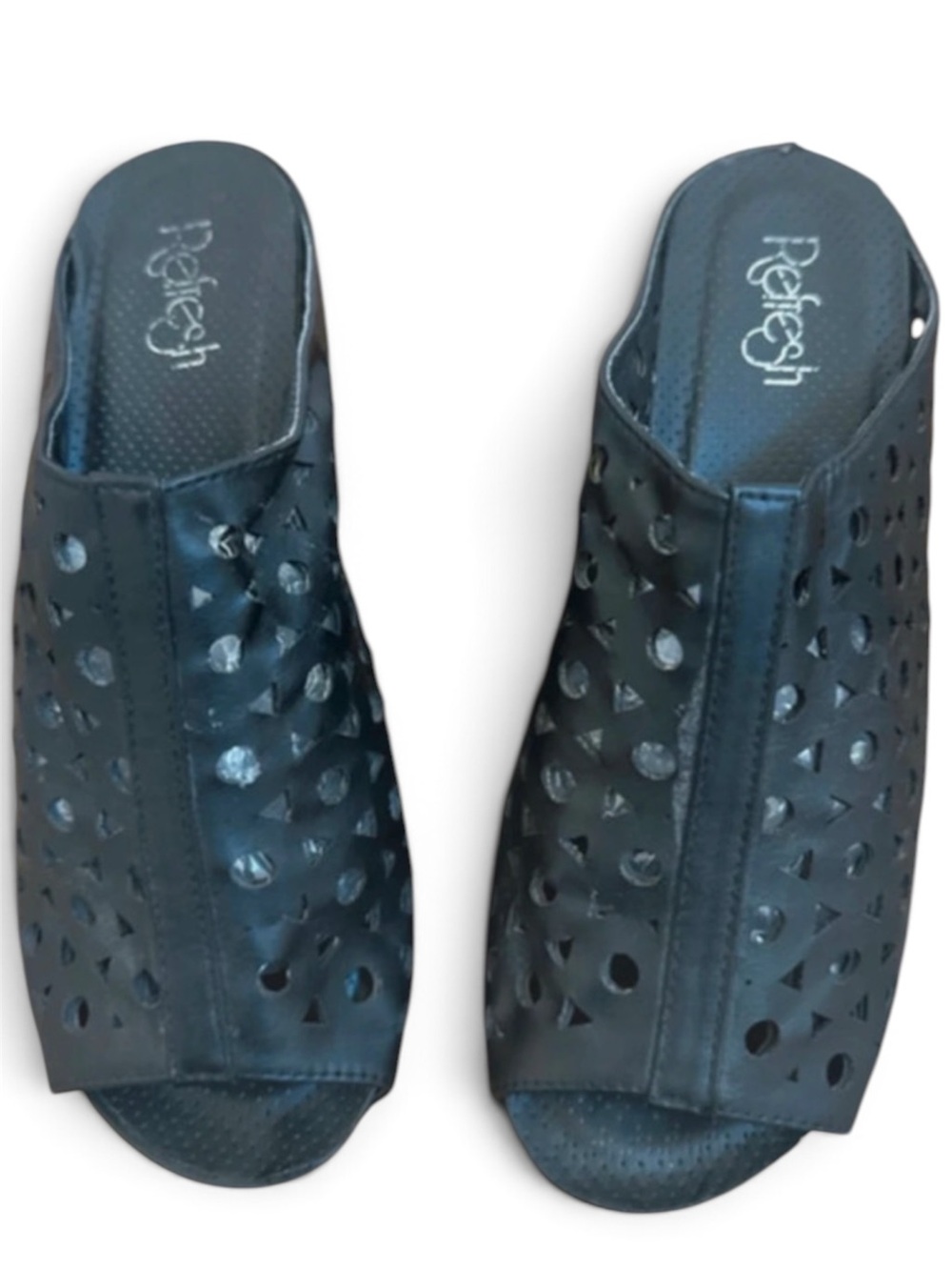 Refresh Mules Black feature a distinctive cutout design and a platform